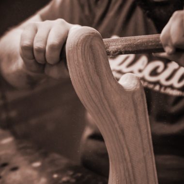 hands shaping piece of wood