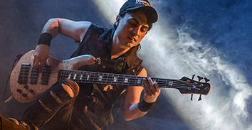 Gustavo Estrada playing electric bass in concert