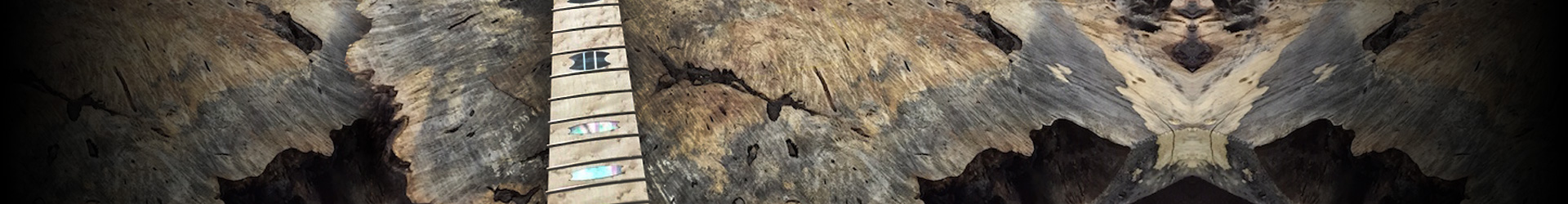 partial view of neck of electric guitar on wood