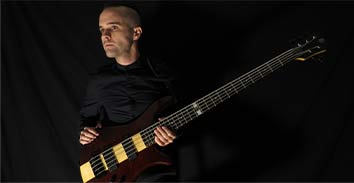 artist, Dan Briggs, holding Spector bass