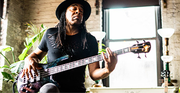 artist, Doug Wimbish, playing Spector bass inside brick building