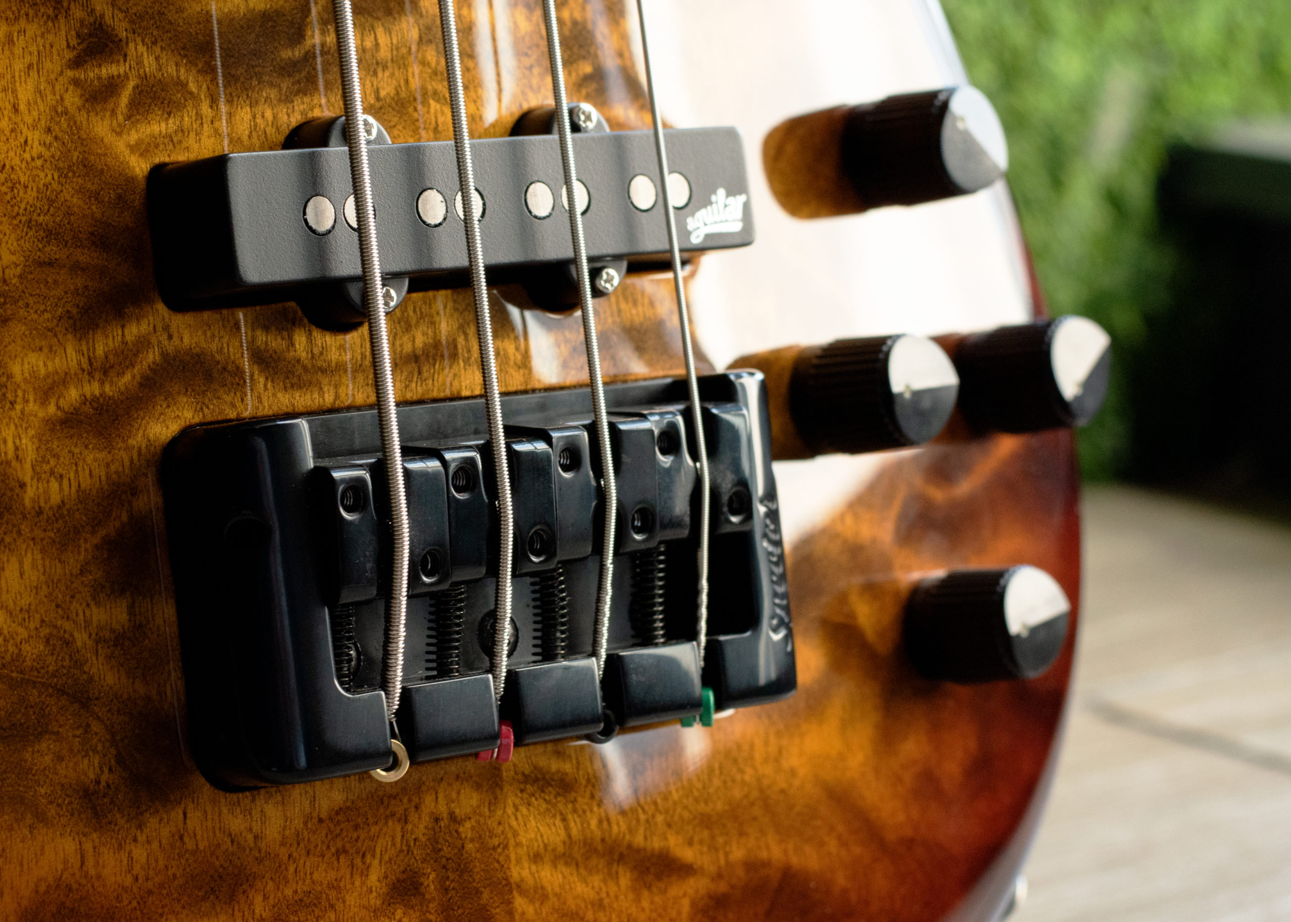 closeup of bridge on orange burst bass