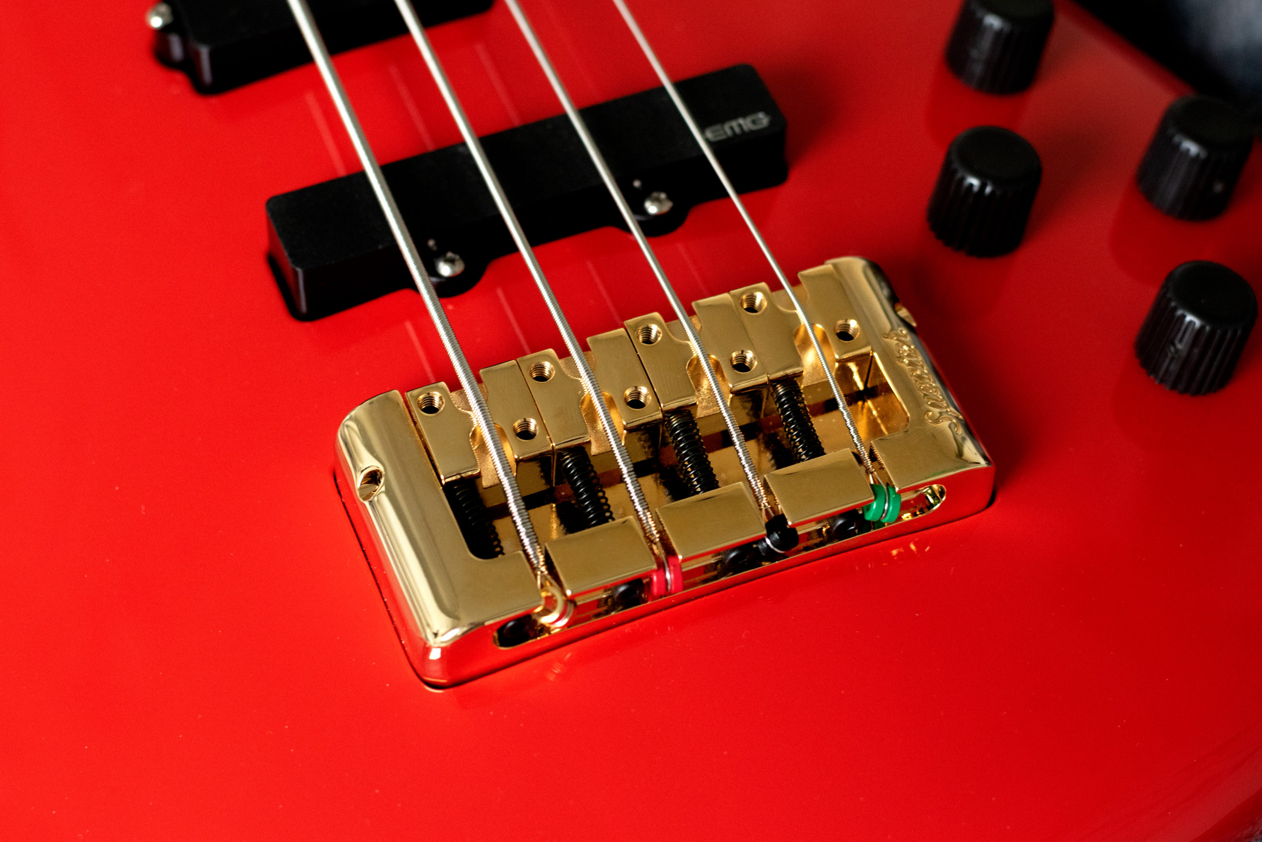 closeup of bridge on red Spector bass