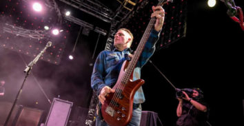 man playing Spector bass in concert