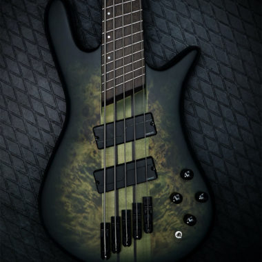 body of green burst Spector bass on black background