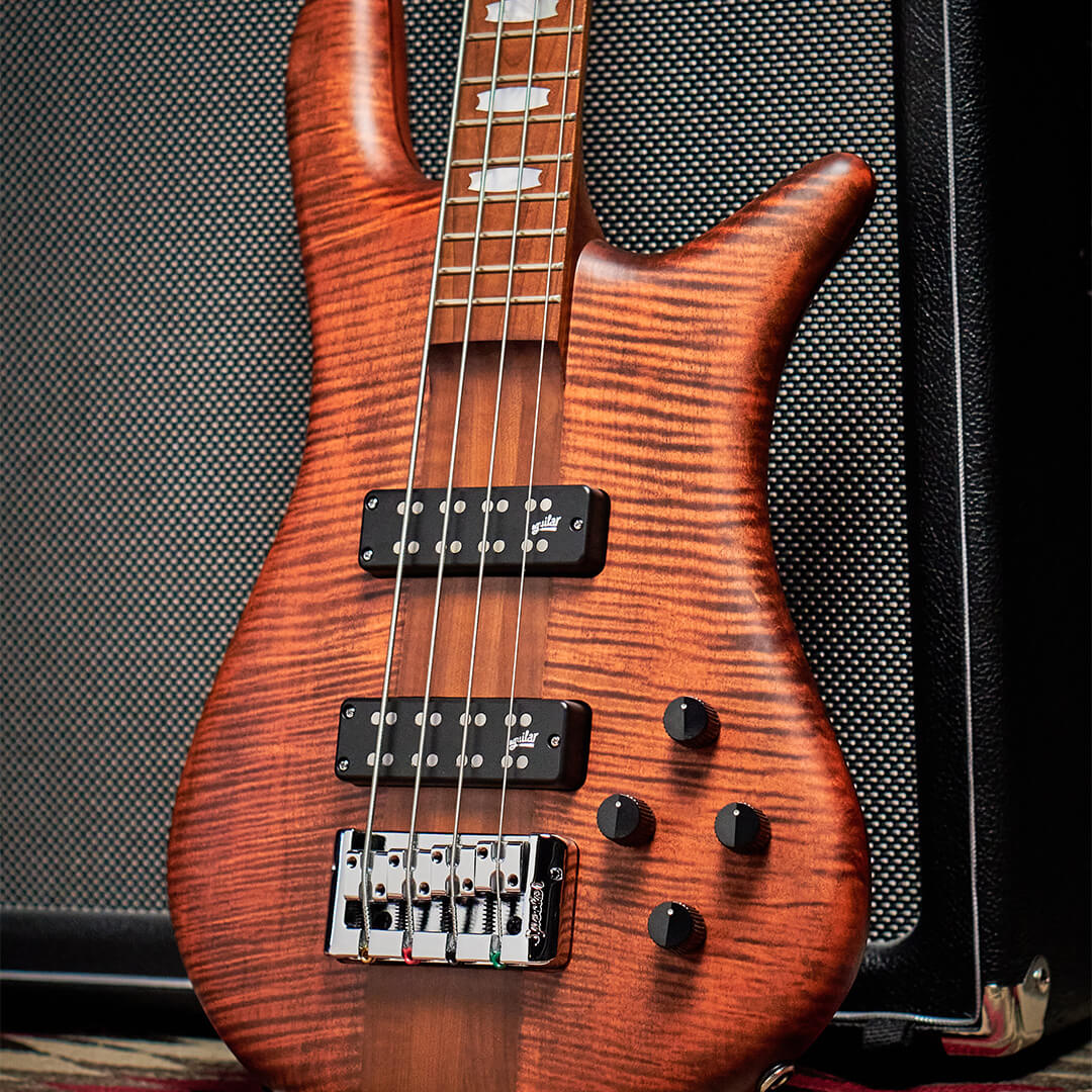 close up of Euro RST bass guitar body in Sienna Stain matte finish leaned against a black amp