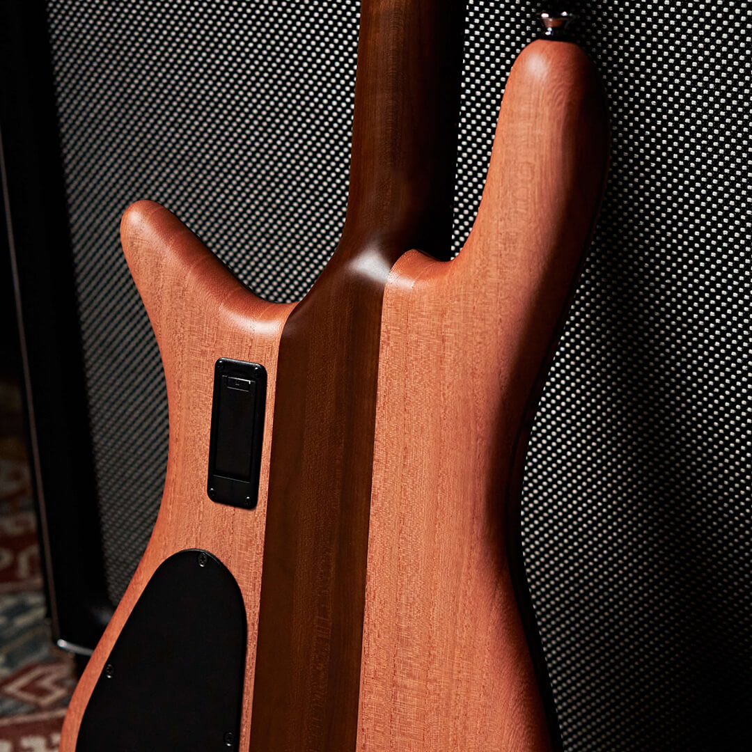 close up of neck-thru construction on Euro RST bass guitar leaning against bass amp